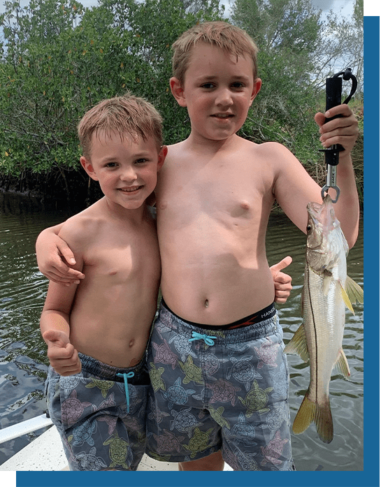 Sue's Grandsons Holding a Snook Fish