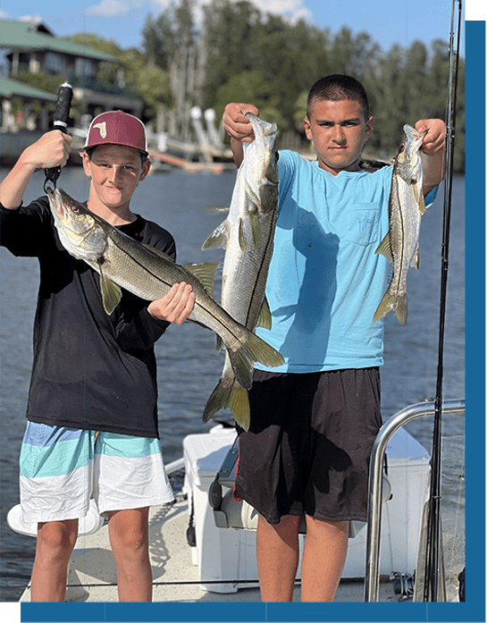 Blayne and Logan Holding Snook Fish