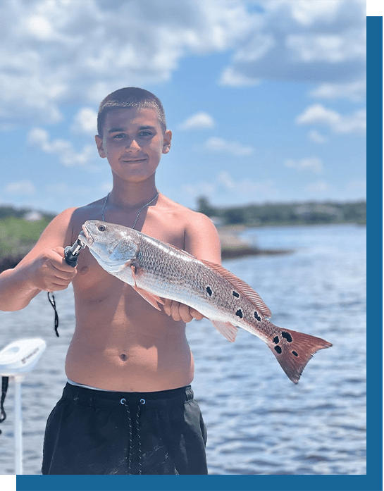 Blayne Holding a Multi-Spot Redfish